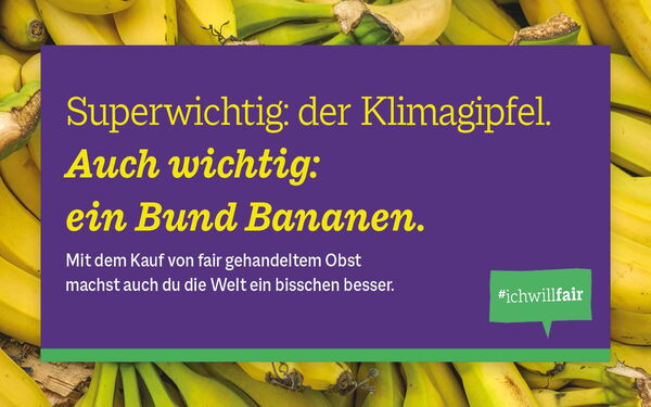 A bunch of yellow bananas is displayed with a purple banner promoting fair trade and climate awareness.